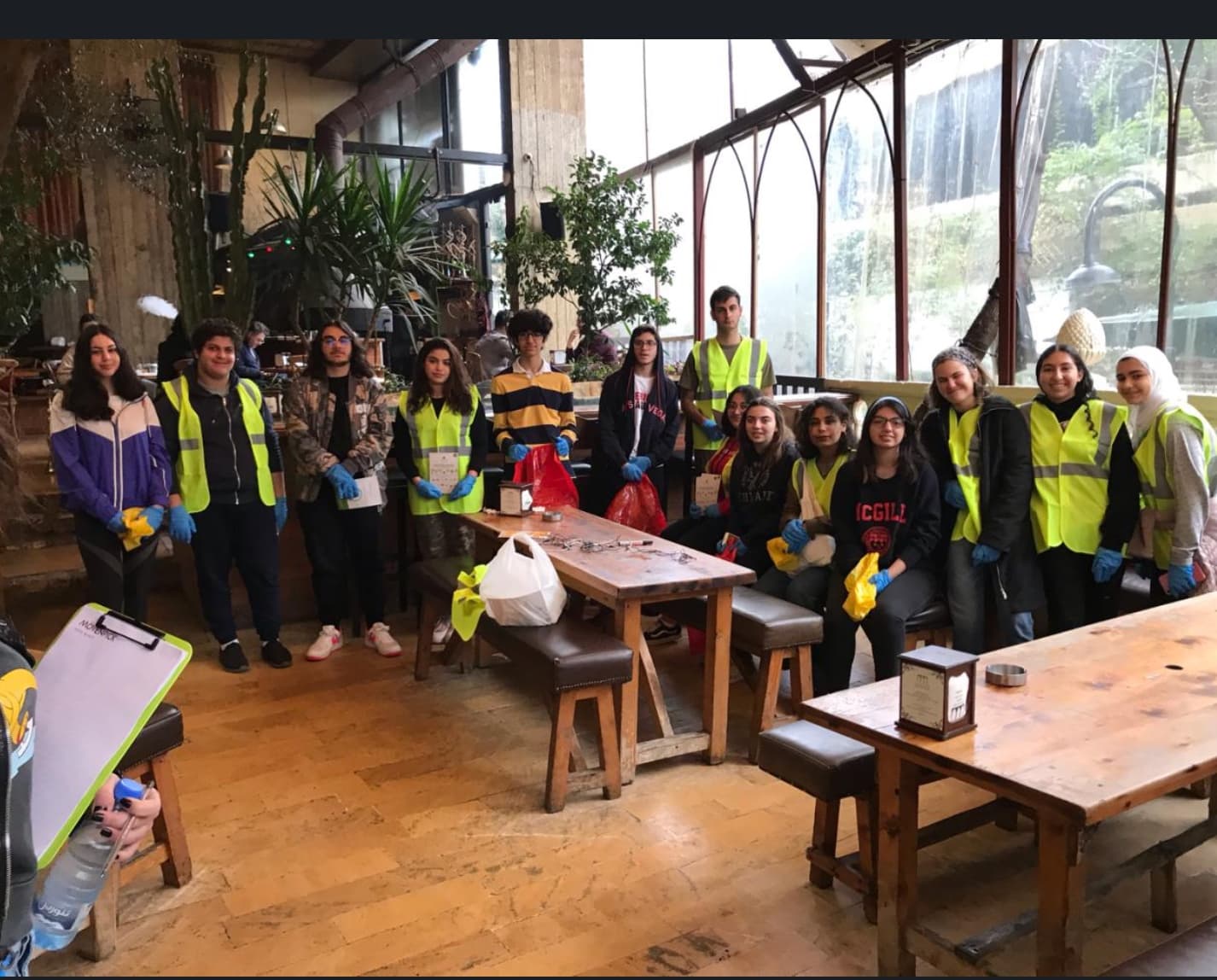 Student volunteers with collection bags inside a restaurant